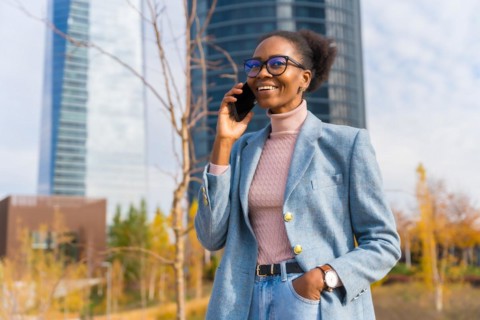 Portrait of black ethnic businesswoman wearing glasses in a business park