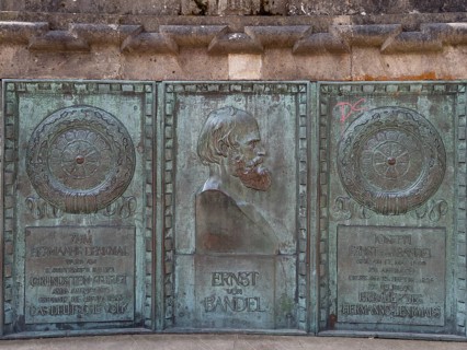 Bronze plaque in honour of the author of the colossal statue Hermann Monument Ernst von Bandel in front of the Hermann Monument