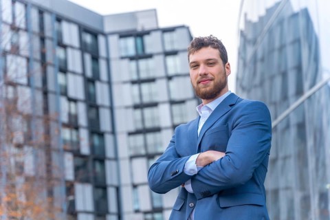Portrait of professional corporate man businessman outside the office in a glass building