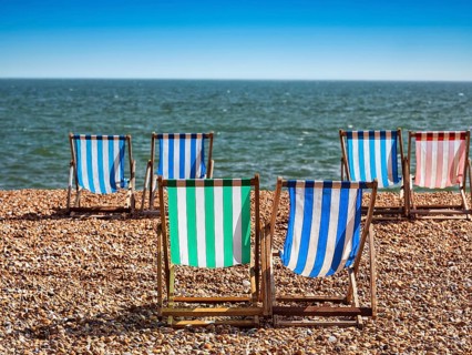 Colourful deckchairs by the sea