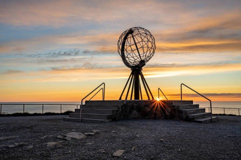 Steel globe at the North Cape under the midnight sun