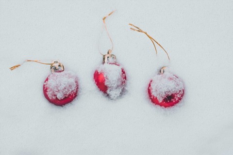 Concept of the postcard with Christmas baubles covered with snow