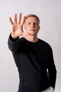Attractive blonde german model in a black jersey on a white background