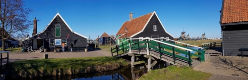 Panoramic photo of Traditional old farmhouse and bridge over a canal in the museum village of Zaanse Schans