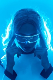 A woman in a futuristic suit and glasses with blue lights