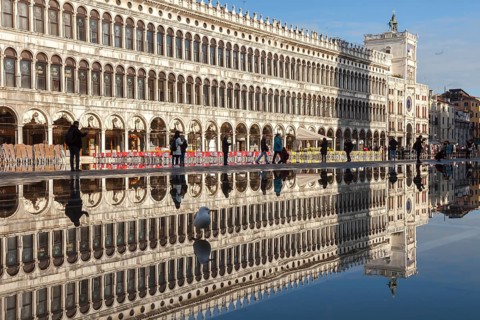 Reflection of the Procuratie Vecchie and the Torre dell Orologio in the high water of the Macus Square