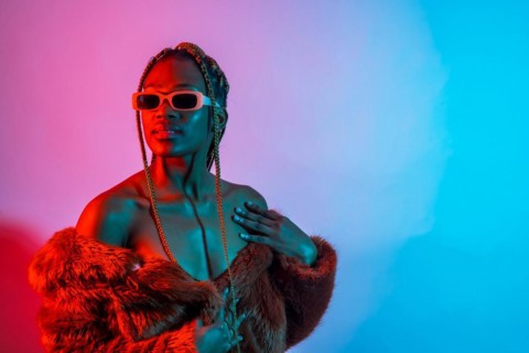 Black ethnic woman with braids with red and blue led lights