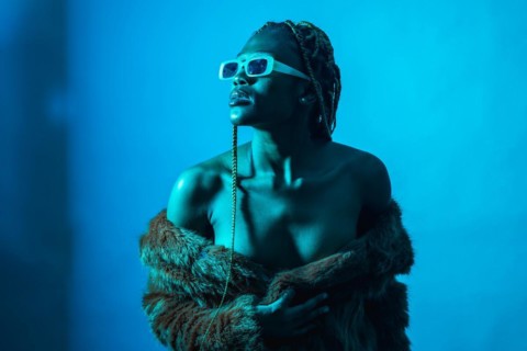 Attractive black ethnic woman with braids with blue led lights