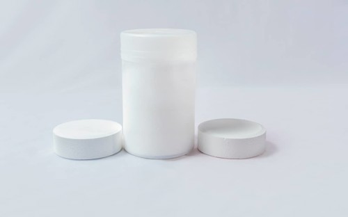 Swimming pool cleaning and maintenance chlorine tablets. Chlorine tablets for pool cleaning on isolated background. Chlorine tablets for swimming pool disinfection on white background