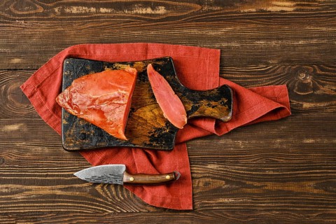 Top view of air dried turkey breast on wooden cutting board