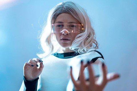 Woman with illuminated futuristic glasses and white hair