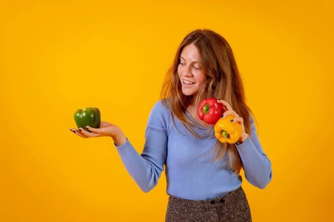 Vegan woman smiling with green