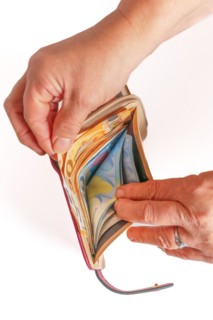 Woman's hands taking euro banknotes out of her wallet with white background and copy space