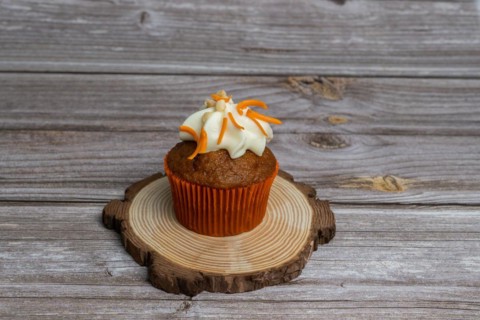 Assortment of chocolate and cream and carrot cupcakes on various backgrounds