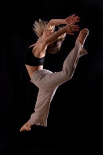 Young dancer in studio photo session with a black background
