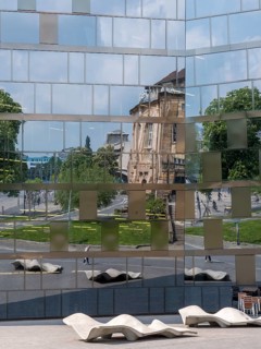 The building of the university library and the reflection on the glass facade of the building