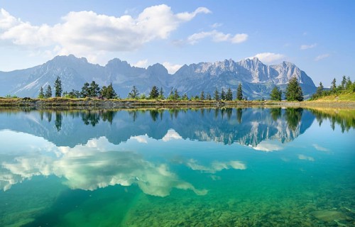 Idyllic Astbergsee with reflection of the mountain panorama