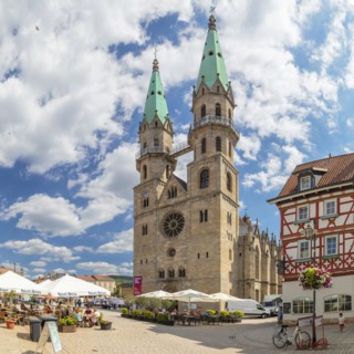 Cafes at the market with the town church of Our Lady