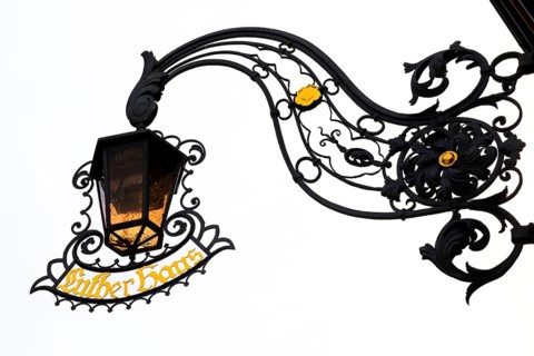 Wrought-iron lamp with nose shield at Luther House