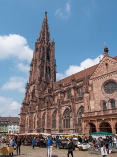 Catholic city parish church Freiburger Muenster with stalls next to it