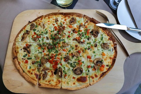 Flammkuchen on wooden board