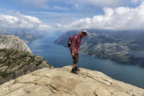 Hiker standing carefully at the rocky outcrop