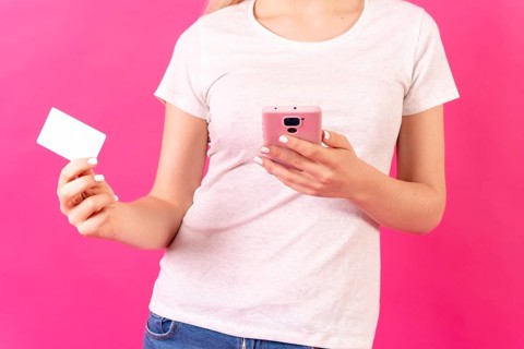 Blonde caucasian girl in pink studio background