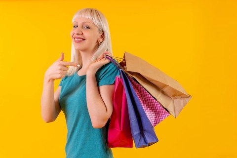 Pointing to shopping bags on sale