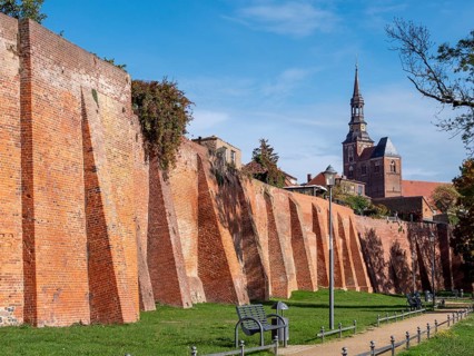 Brick city wall and in the background the Protestant Church of St. Stephan