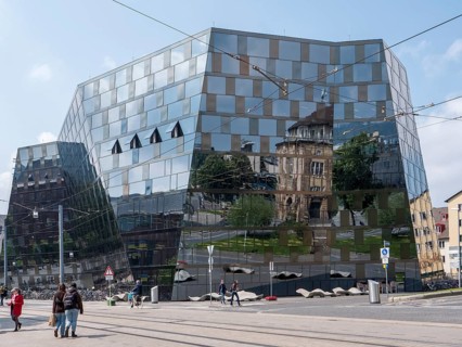 The building of the university library and the reflection on the glass facade of the building