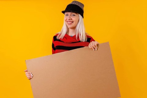Holding empty cardboard advertisement poster