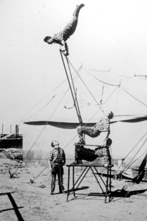 Old archival black and white photograph from the 1920s showing acrobats