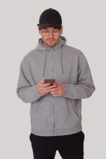 Fashionably sporty man typing on his mobile phone