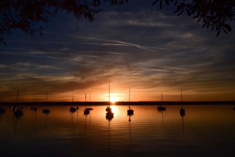 Sailing boats in the sunset in Herrschinger Bucht on Lake Lake Ammer