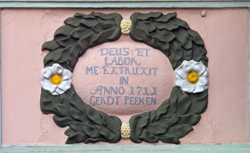Ornament and inscription on an old dwelling house in Jever from 1711