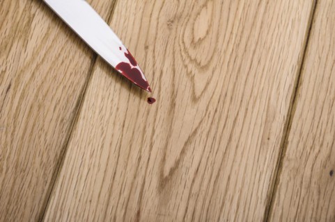 Bloodstained knife on a wooden floor