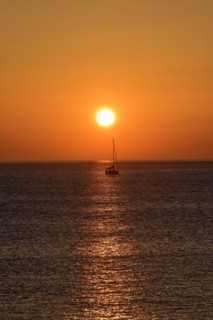 Sunset with sailboat on the Atlantic Ocean in Normandy