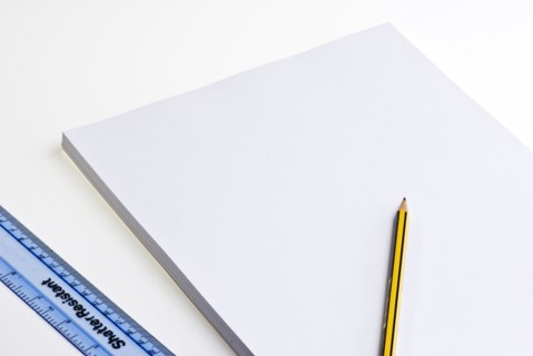 Blank pad of white paper with a pencil and plastic ruler