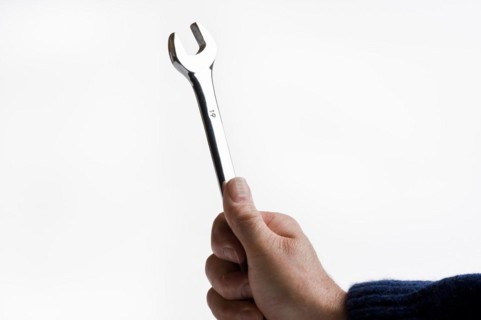 Man holding a chrome plated spanner