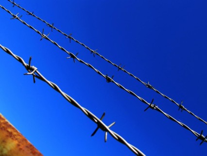 Barbed wire against a blue sky