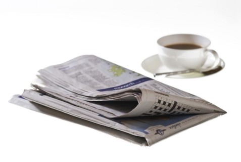 Folded newspaper on white background