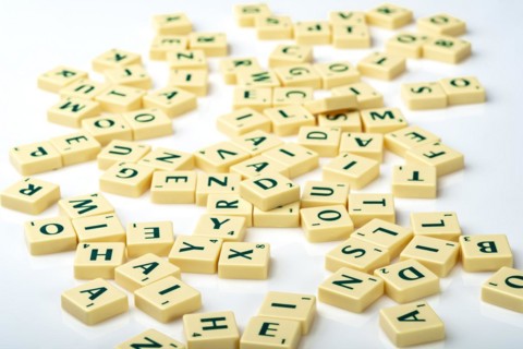 Scrabble tiles thrown down in a random chaotic way