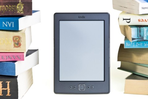 Kindle e reader with a large pile of books