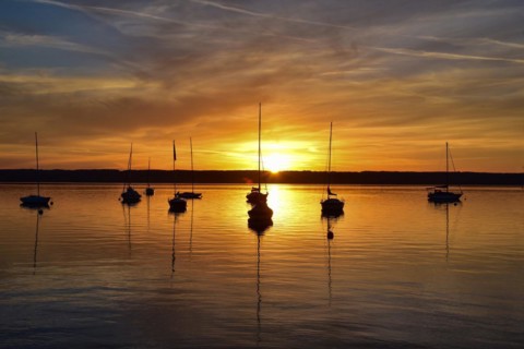 Sailing boats in the sunset in Herrschinger Bucht on Lake Lake Ammer