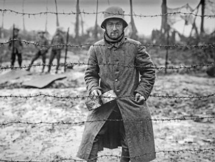 WWI German prisoner of war behind barbed wire of POW camp at Langemarck