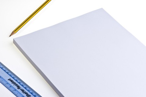 Blank pad of white paper with a pencil and plastic ruler