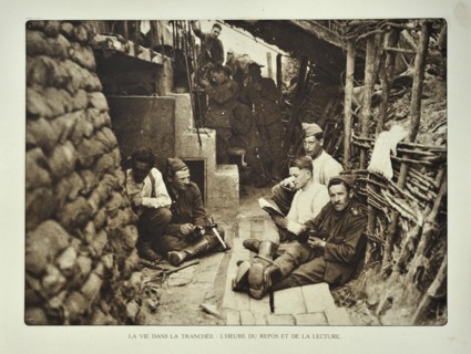 Soldiers resting and reading books at shelter in trench in Flanders during the First World War