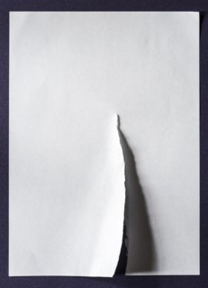 White sheet of paper with a tear