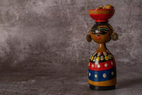 Hand-painted terracotta figure of a traditional handmade woman in close-up isolated close-up