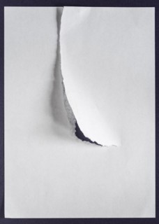 White sheet of paper with a tear